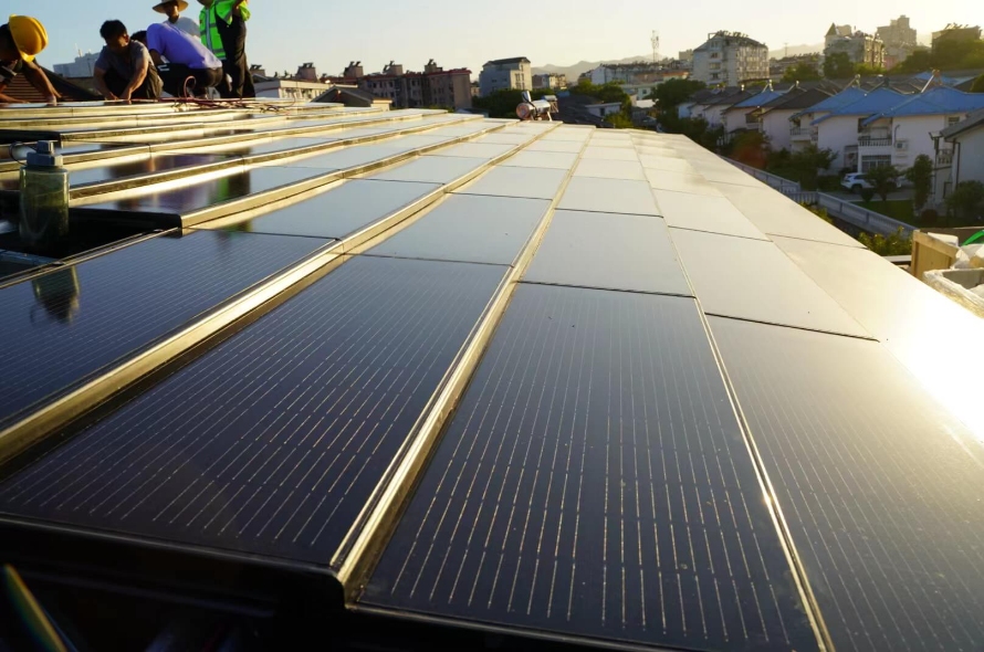 Workers are installing solar roof tiles